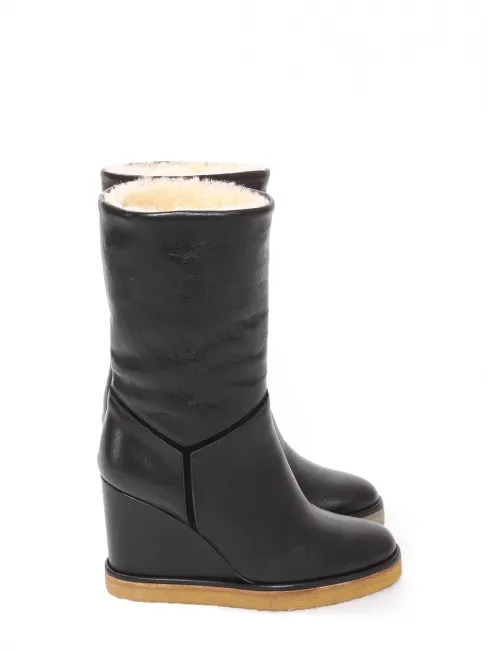 Bottes compensées en cuir noir et shearling blanc Prix boutique 1000€ Taille 36